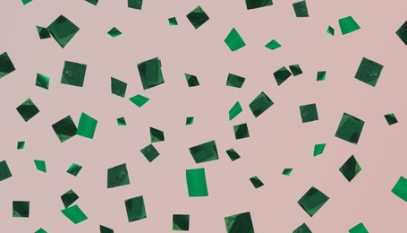 Image of Shiny green confetti falling on dark beige background. Banner design
