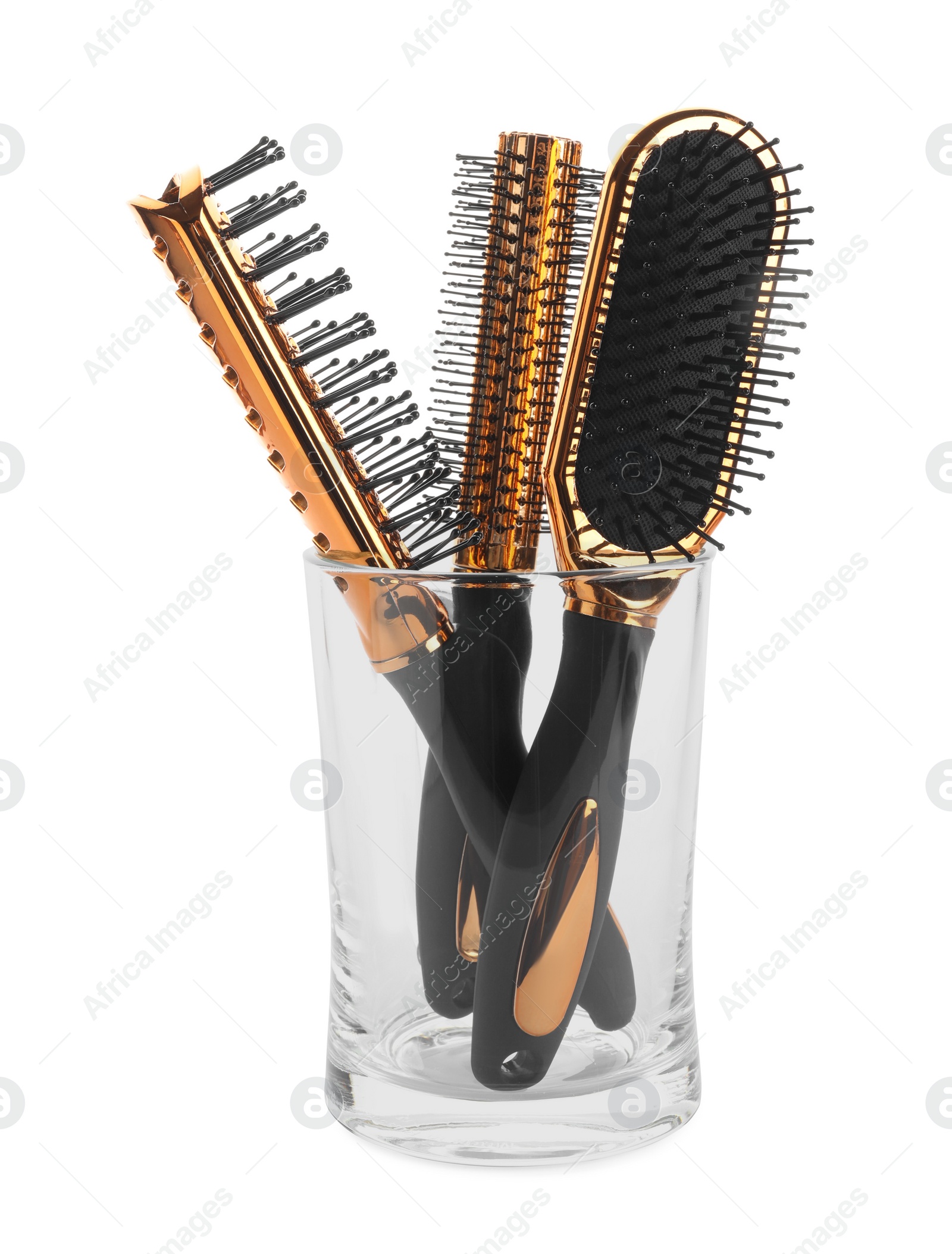 Photo of Set of professional hair brushes in glass holder isolated on white