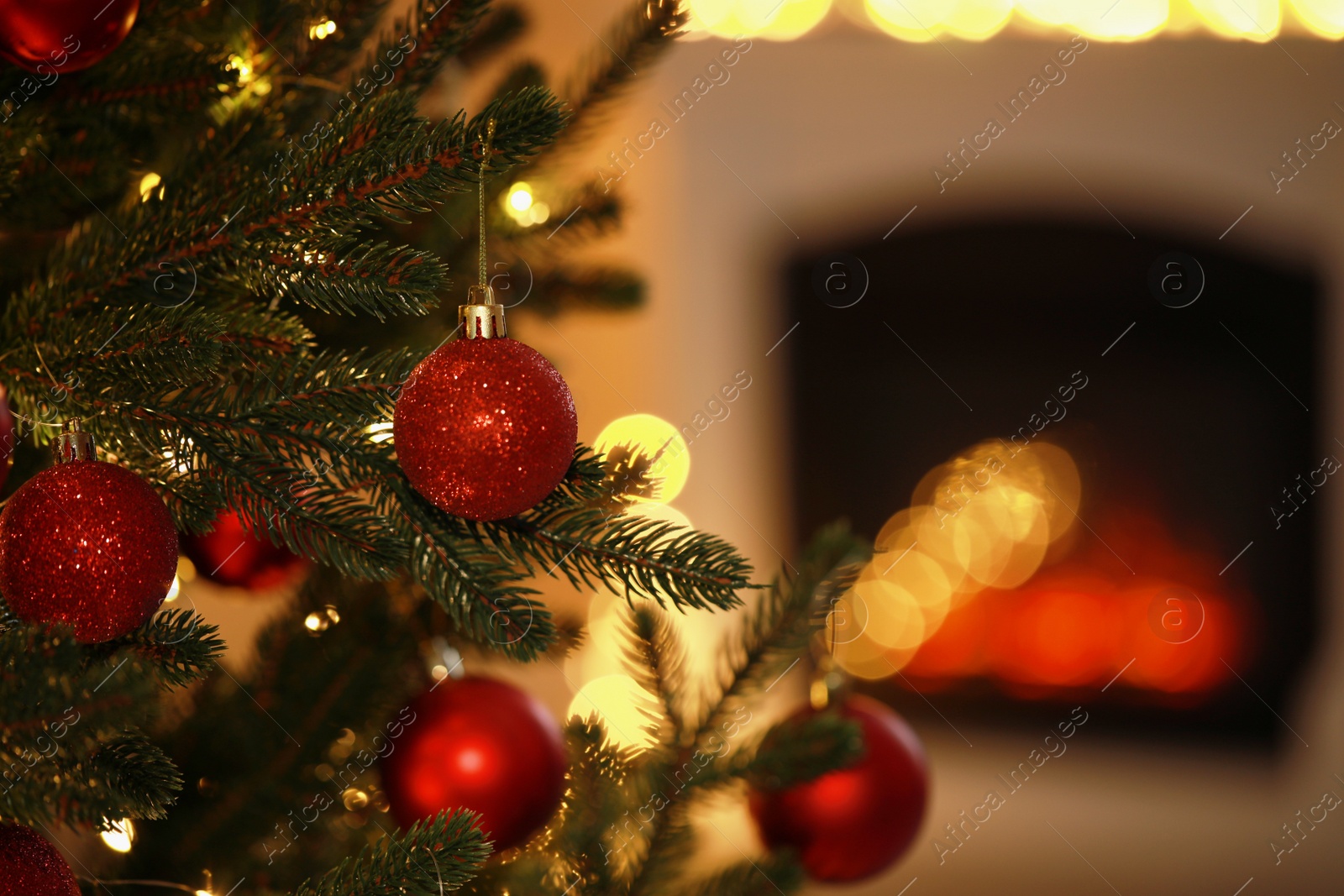 Photo of Beautiful Christmas tree decorated with festive lights and baubles indoors, space for text. Bokeh effect