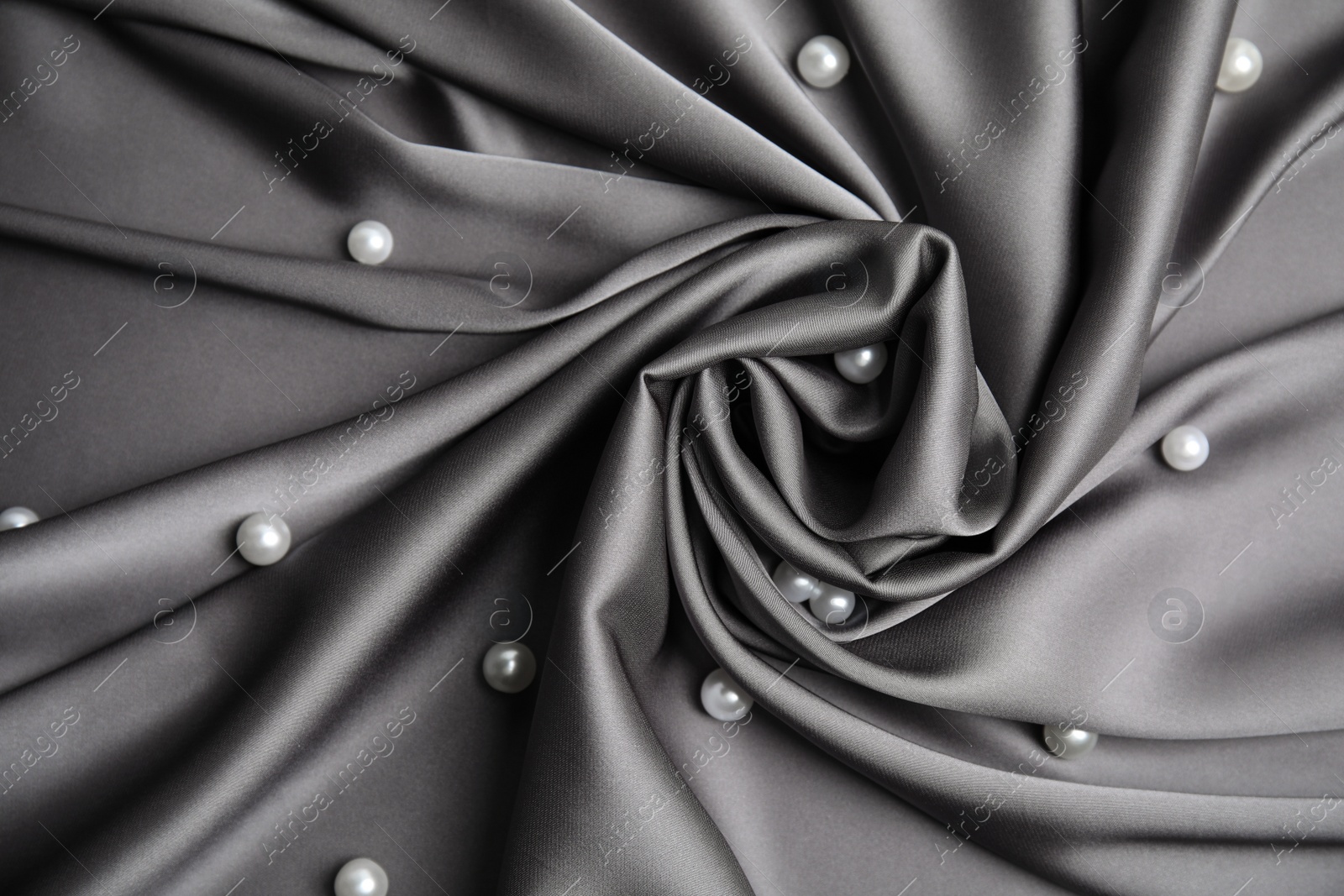 Photo of Many beautiful pearls on delicate black silk, flat lay