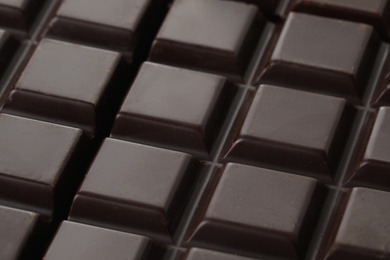 Delicious dark chocolate as background, closeup view