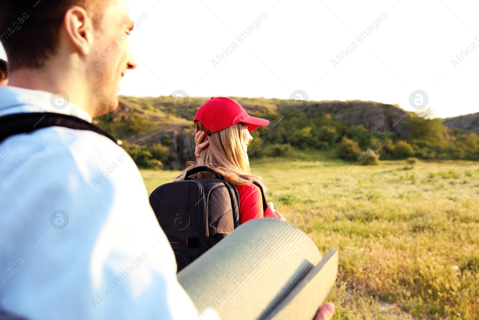 Photo of Young people hiking in wilderness. Camping season