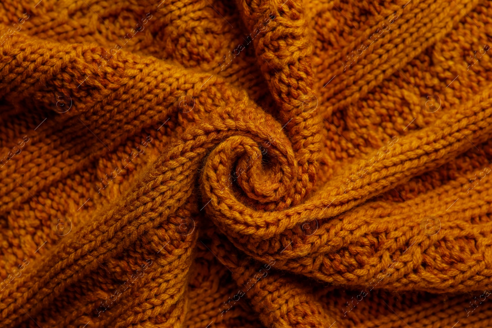 Photo of Beautiful orange knitted fabric as background, top view