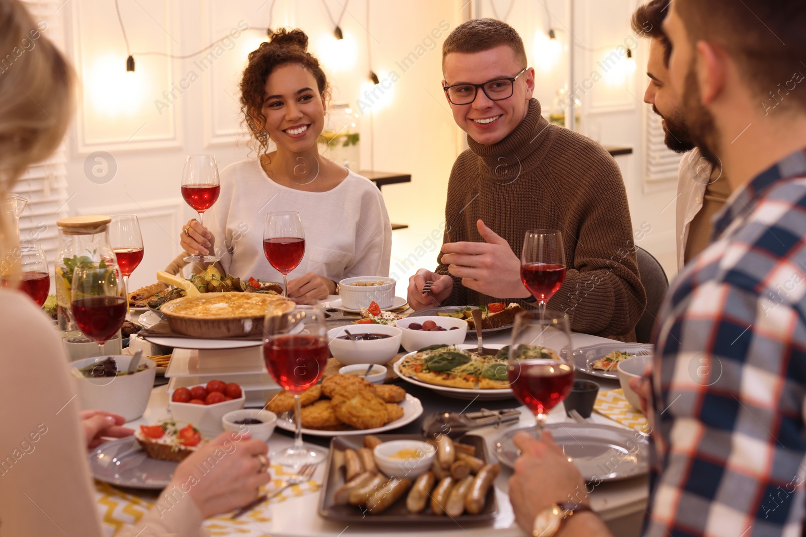 Photo of Group of people having brunch together at table indoors