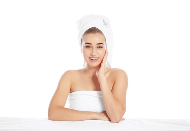 Photo of Portrait of young pretty woman with towels on white background