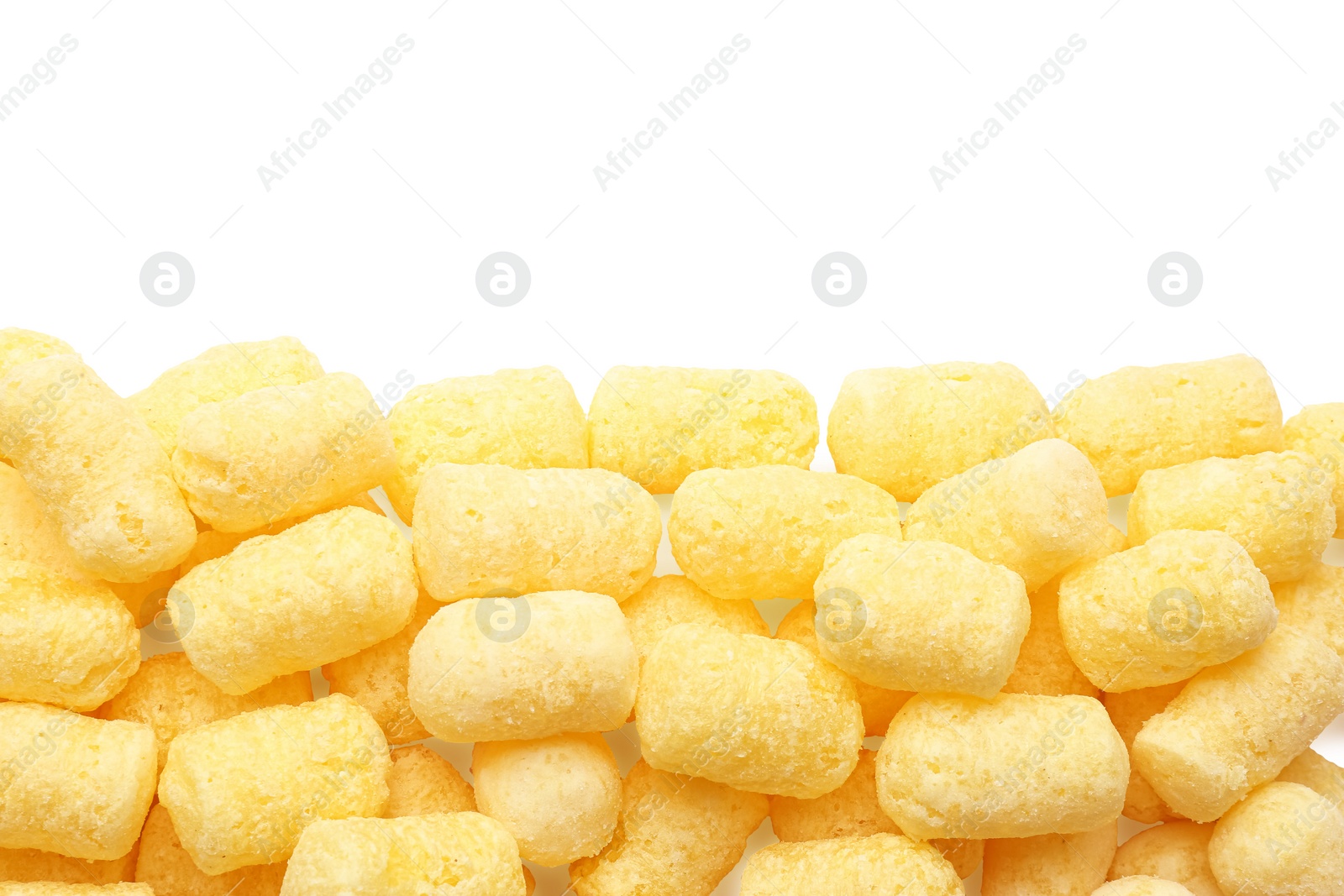 Photo of Many tasty corn puffs on white background, top view