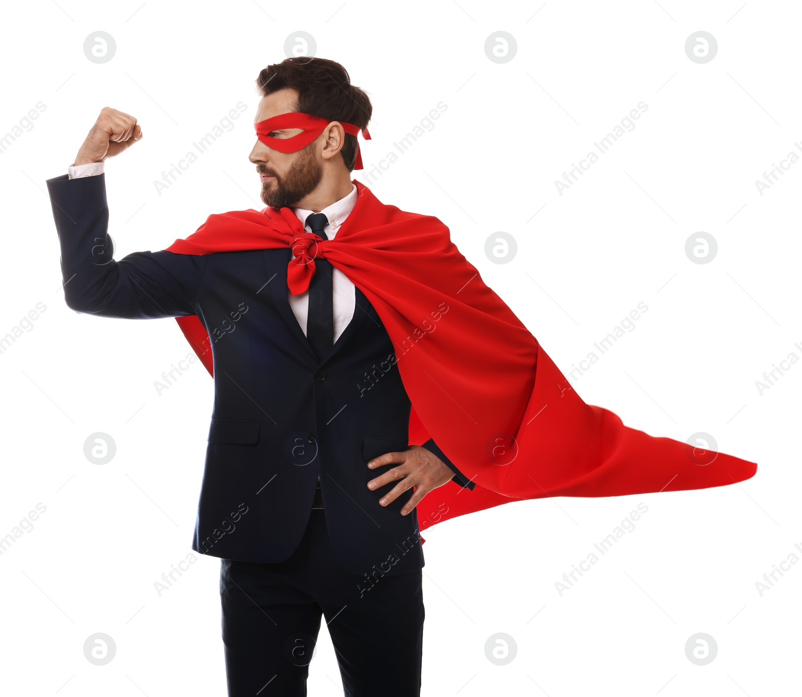 Photo of Confident businessman wearing red superhero cape and mask on white background