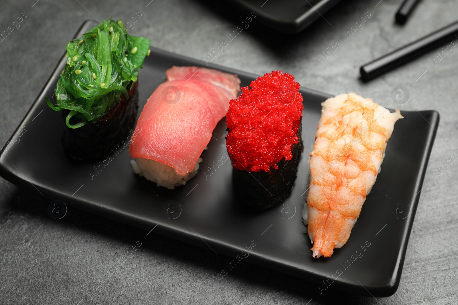 Photo of Set of delicious sushi on grey table