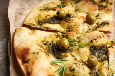 Delicious focaccia bread with green olives, closeup