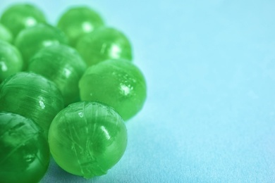 Refreshing tasty mint candies on table, closeup