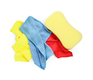 Photo of Sponge and car wash cloths on white background, top view