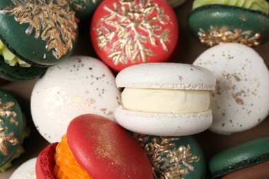 Photo of Beautifully decorated Christmas macarons as background, closeup