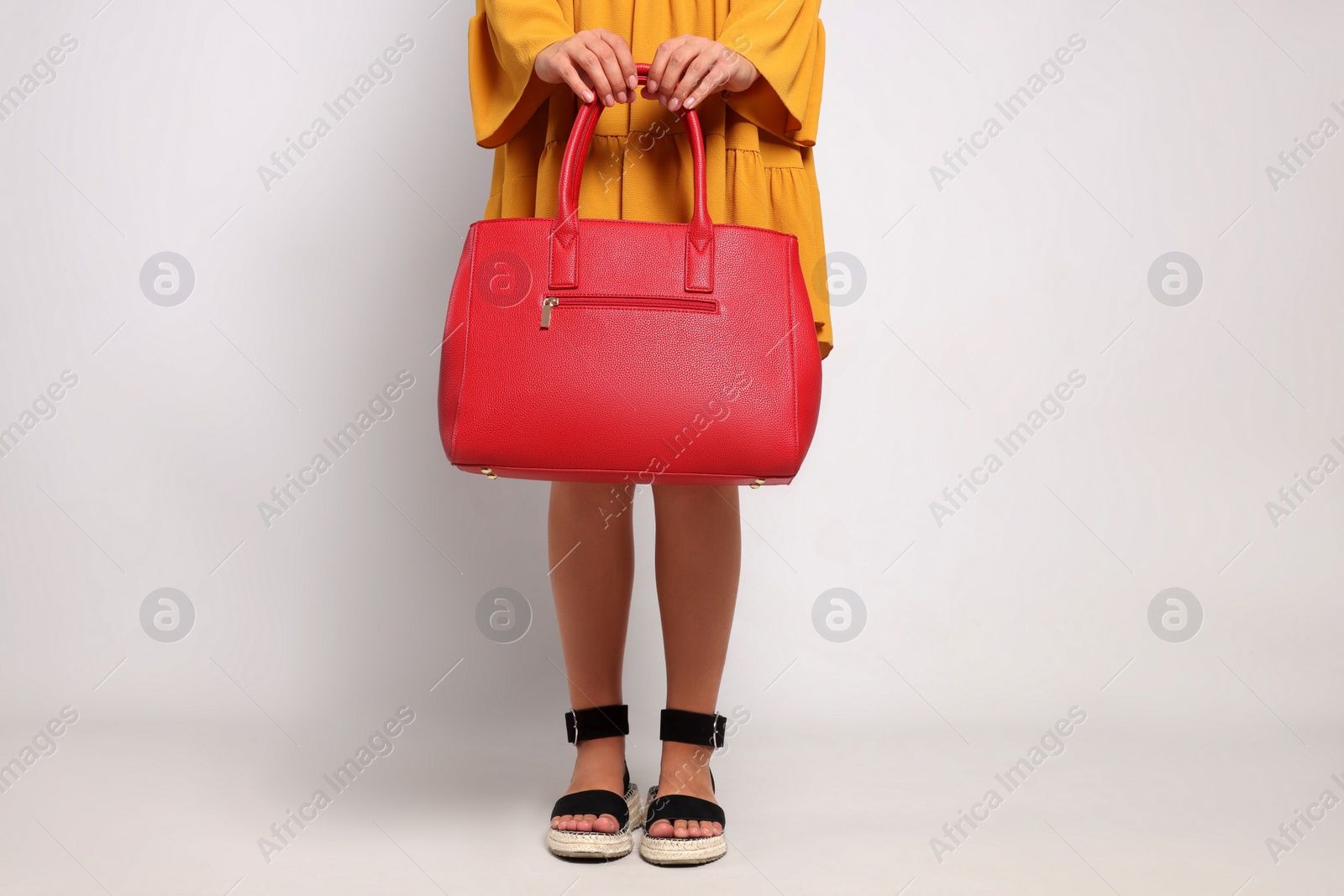 Photo of Young woman with stylish bag on white background, closeup