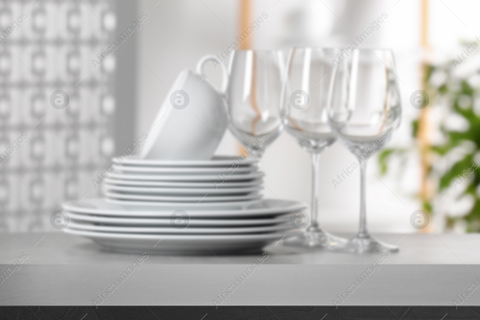 Image of Set of clean dishware, focus on empty stone table