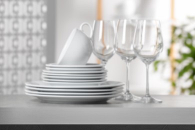 Set of clean dishware, focus on empty stone table