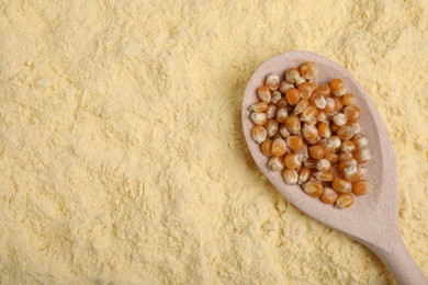 Photo of Spoon with corn grains on flour, top view. Space for text