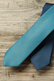 Photo of Two neckties on wooden table, top view