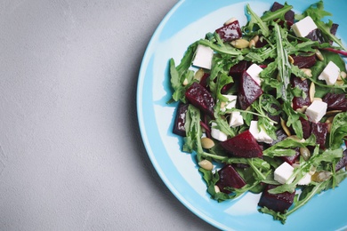 Photo of Fresh delicious beet salad on grey table, top view. Space for text