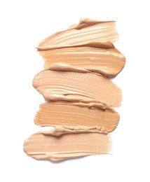 Photo of Samples of skin foundation on white background, top view