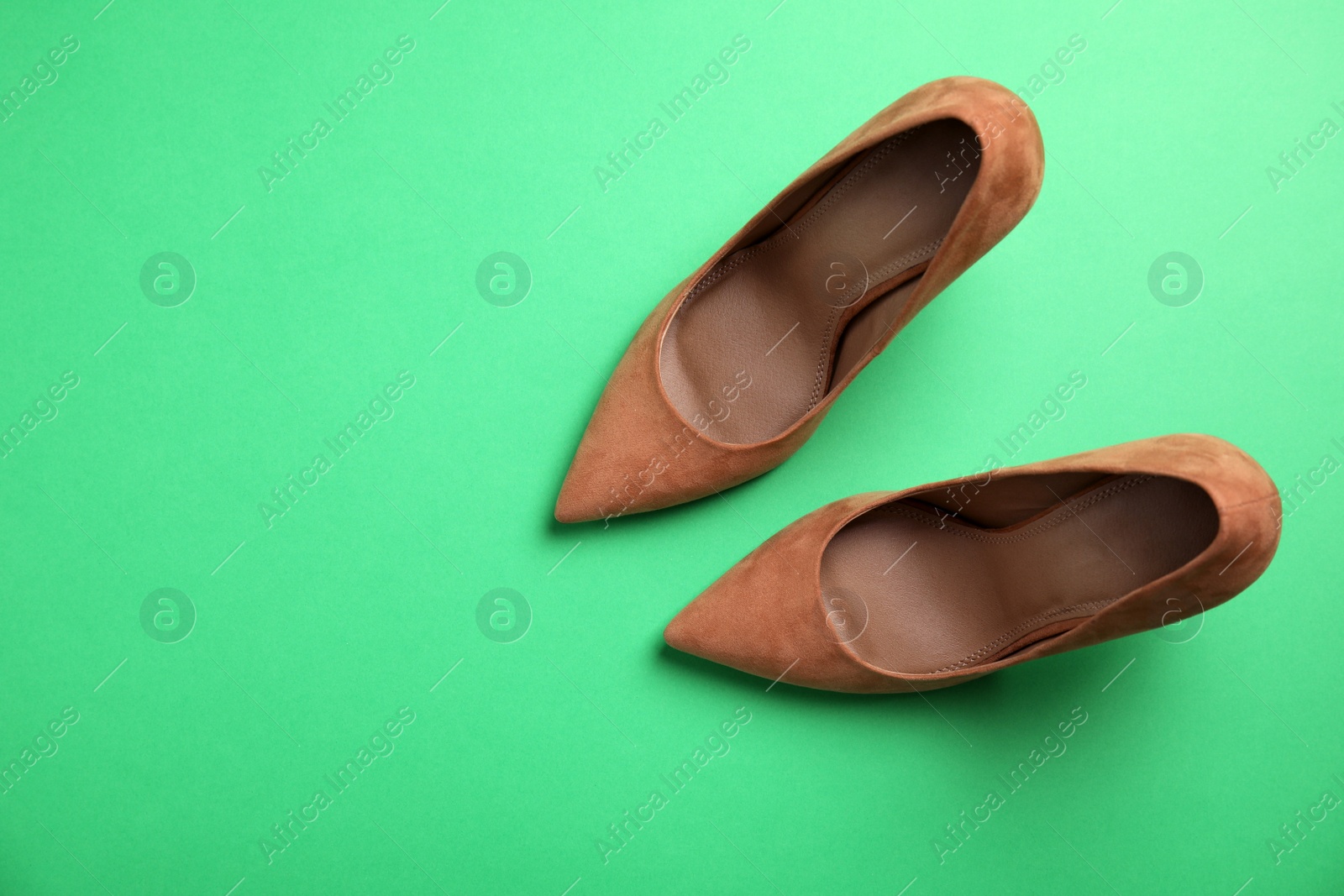 Photo of Pair of beautiful shoes and space for text on color background, top view