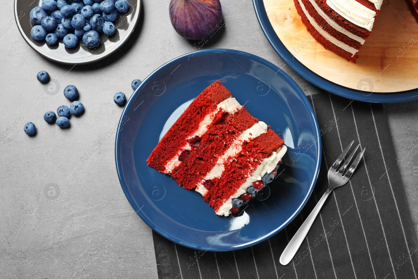 Photo of Delicious homemade red velvet cake served on table, flat lay