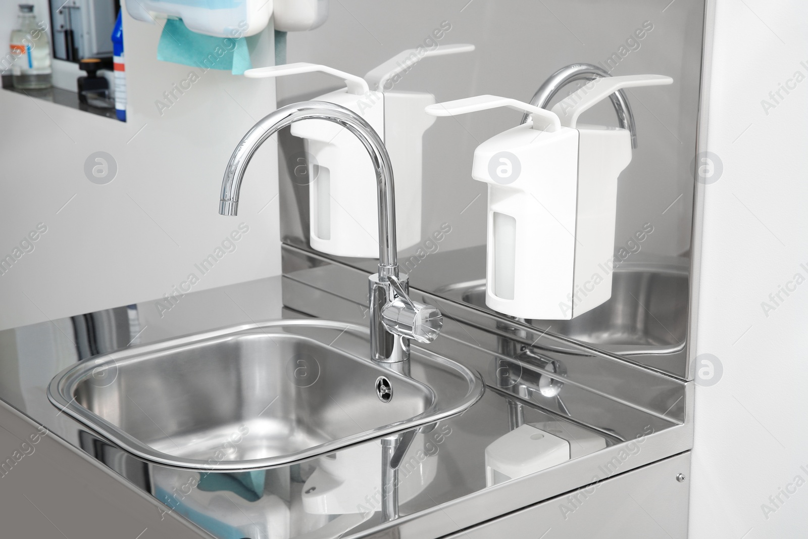 Photo of Sterile steel washbasin in modern surgery room