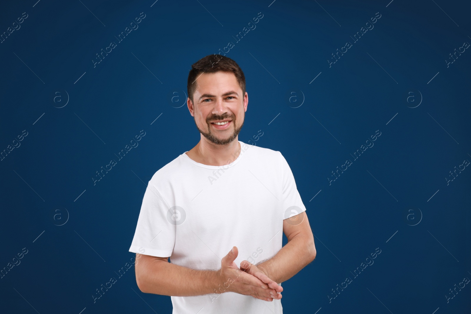 Photo of Portrait of handsome man on blue background