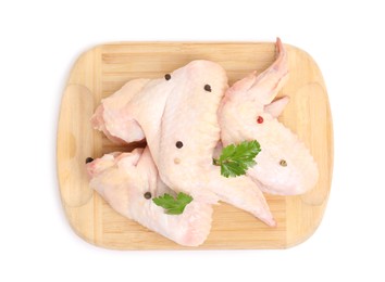 Photo of Raw chicken wings with spices and parsley on white background, top view