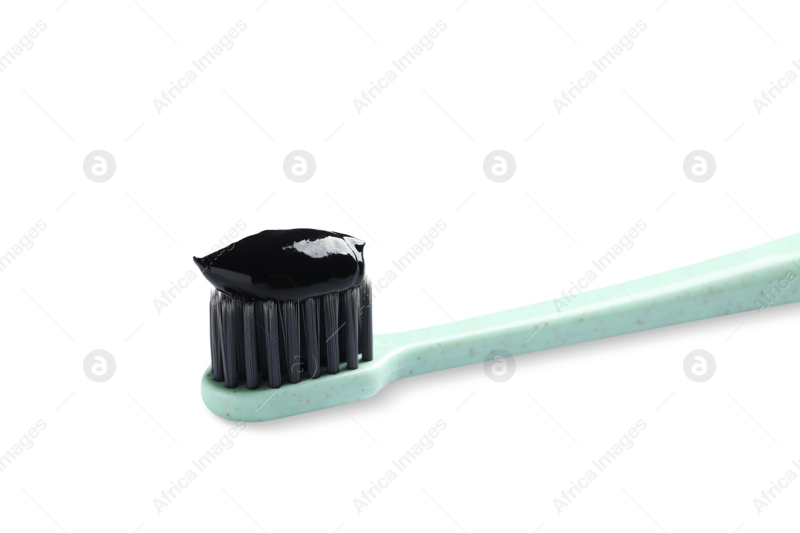 Photo of Brush with charcoal toothpaste isolated on white