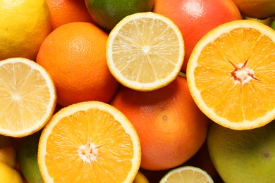 Photo of Different fresh citrus fruits as background, top view