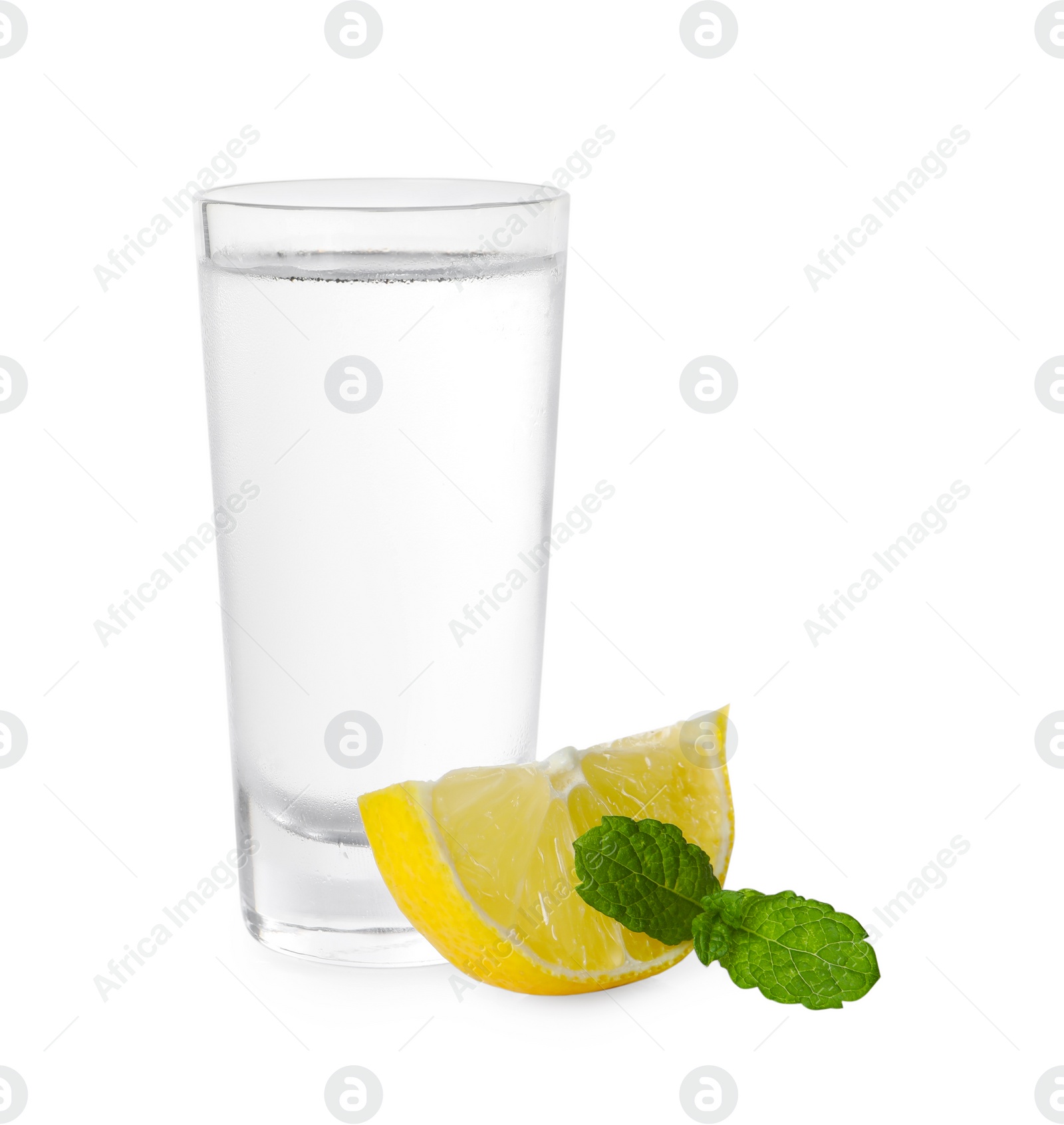 Photo of Glass of vodka, mint and lemon isolated on white