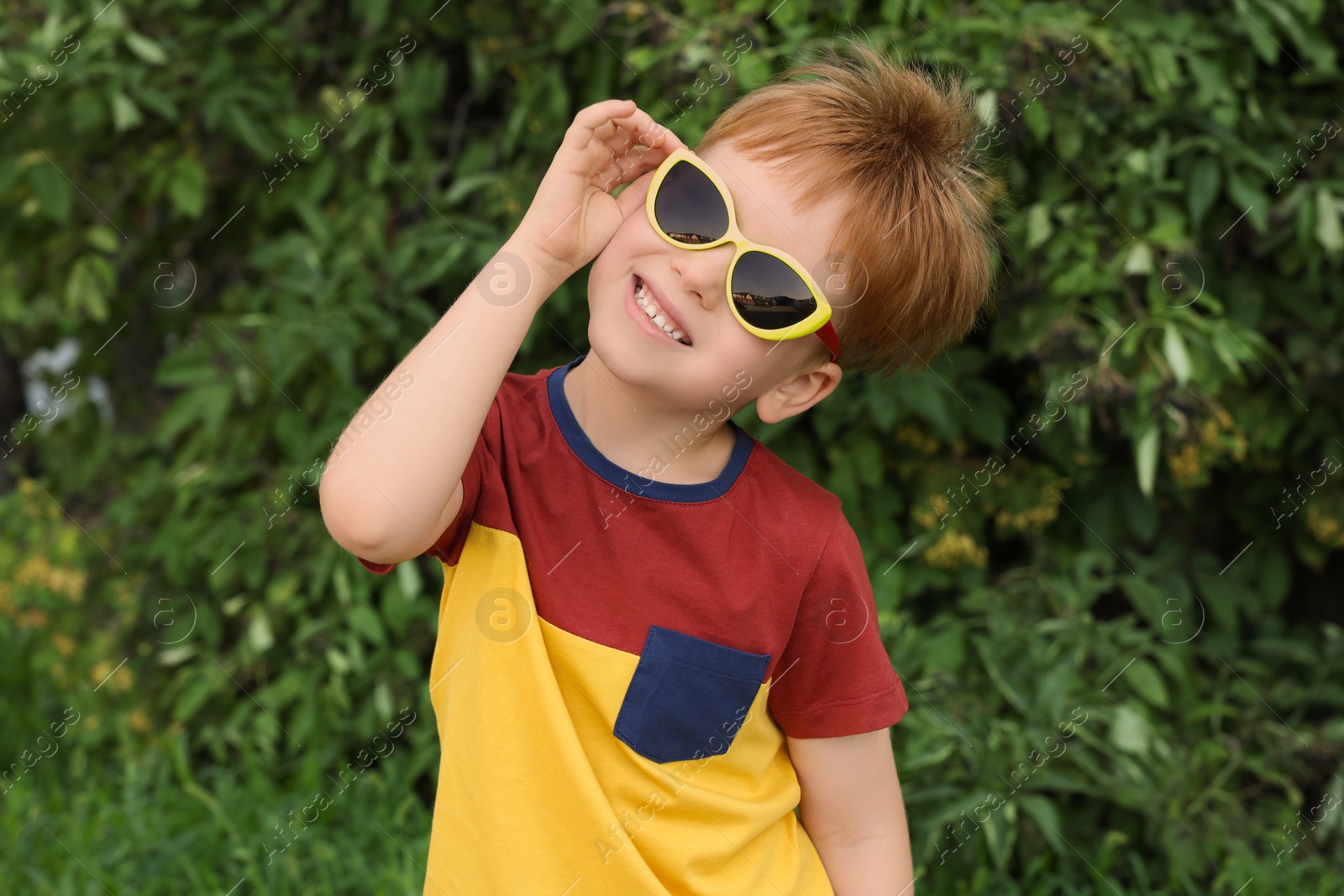 Photo of Cute little boy with sunglasses in park