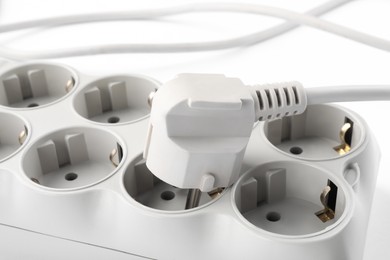 Photo of Power strip on white background, closeup. Electrician's equipment