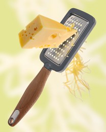 Image of Grating cheese with hand grater on yellowish green background