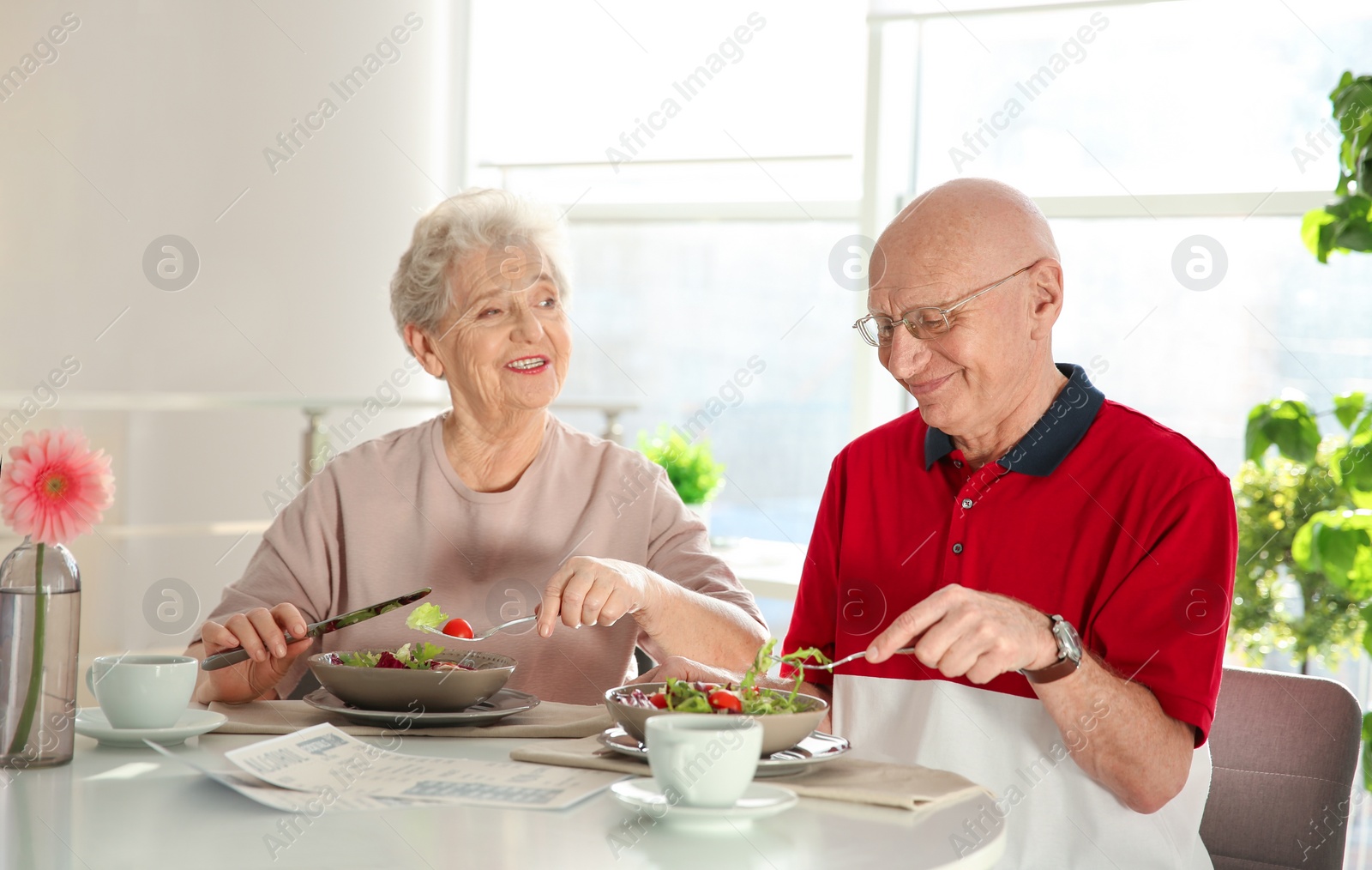 Photo of Elderly couple having breakfast at home