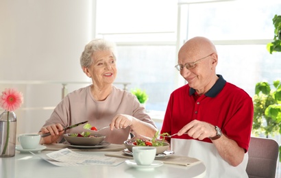 Elderly couple having breakfast at home