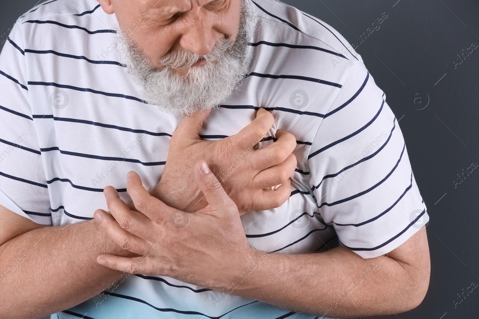 Photo of Mature man having heart attack, closeup