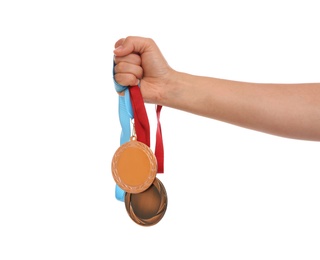 Photo of Woman holding gold and bronze medals on white background, closeup