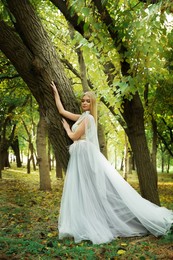 Beautiful girl wearing fairy dress in autumn forest