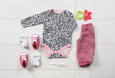 Flat lay composition with stylish child clothes on wooden background