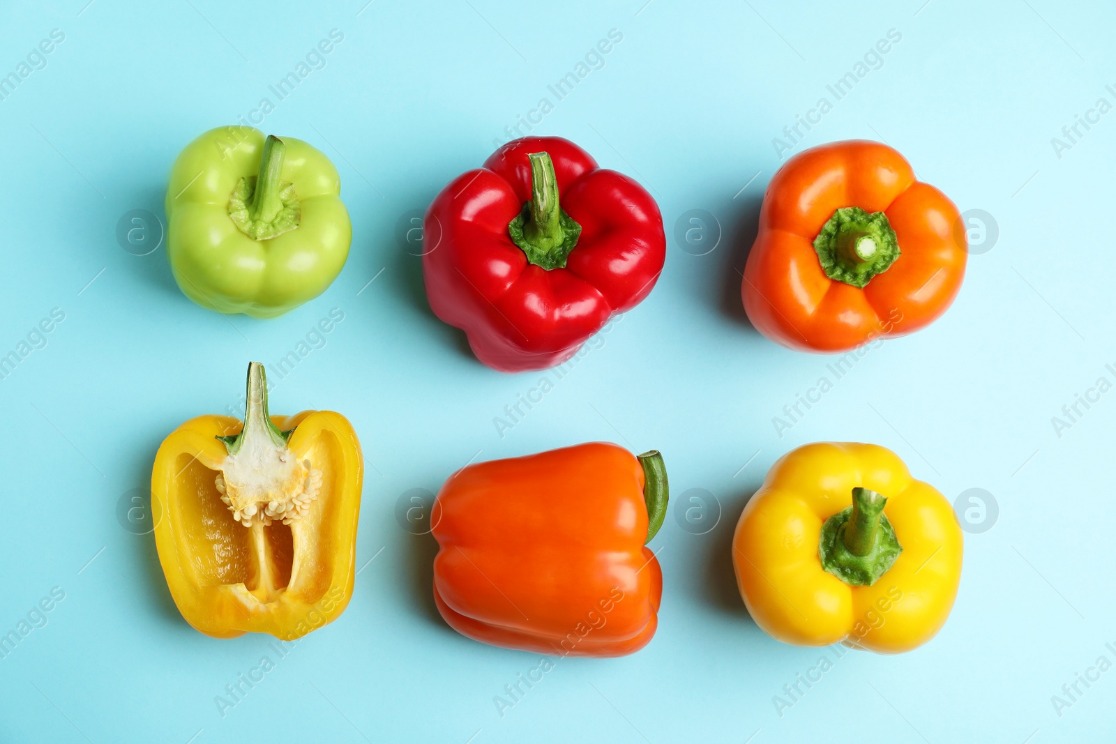 Photo of Flat lay composition with ripe bell peppers on blue background