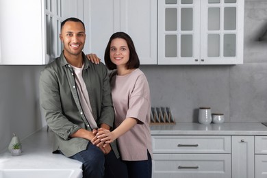 Photo of Dating agency. Happy couple spending time together in kitchen