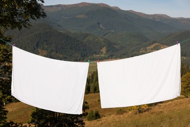 Photo of Laundry with clothes pins on line outdoors