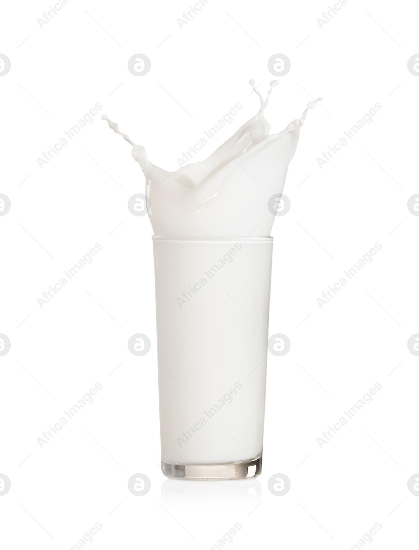 Photo of Milk splashing out of glass on white background