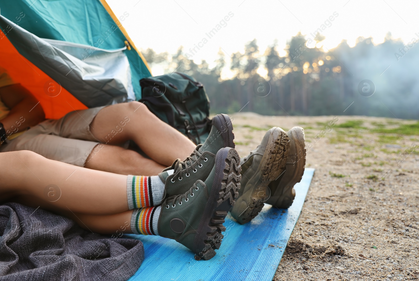 Photo of Young couple resting in camping tent together