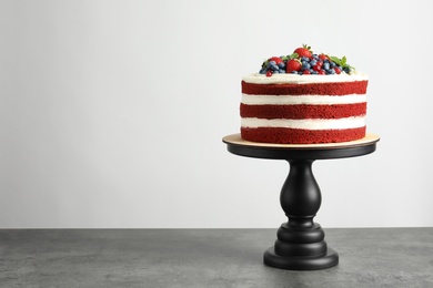 Photo of Delicious homemade red velvet cake and space for text on light background