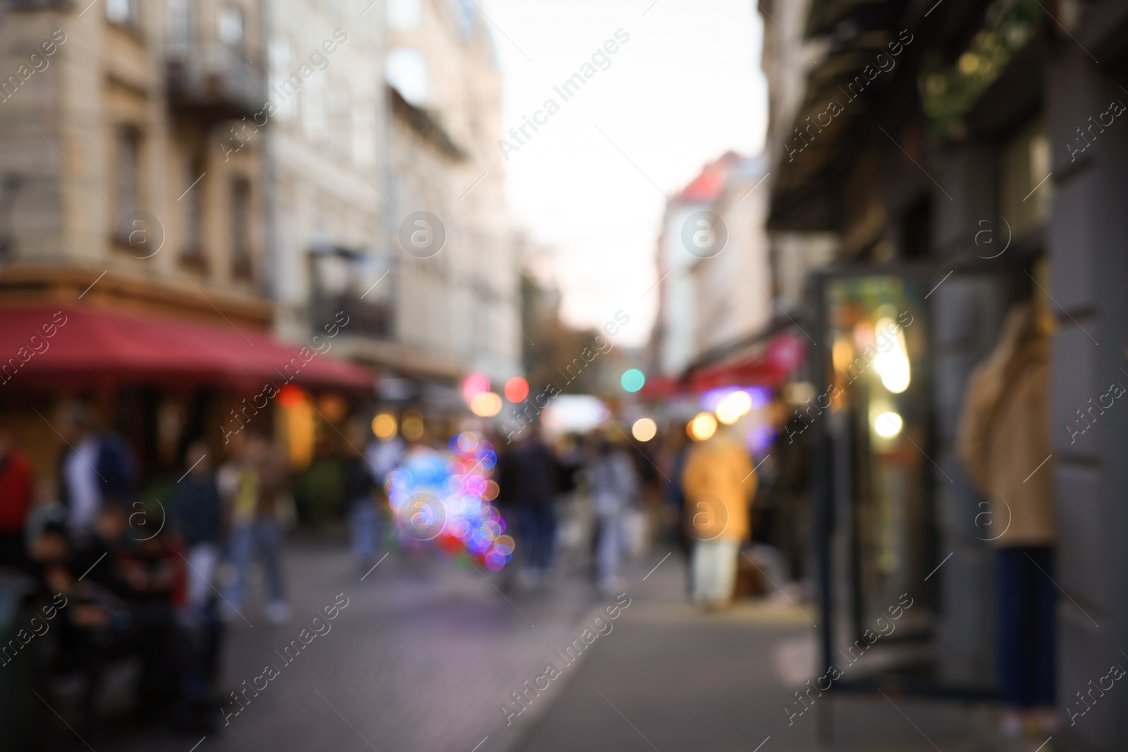 Photo of Blurred view of people walking on city street