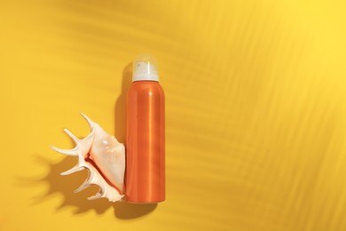 Sunscreen and seashell on yellow background, flat lay and space for text. Sun protection care