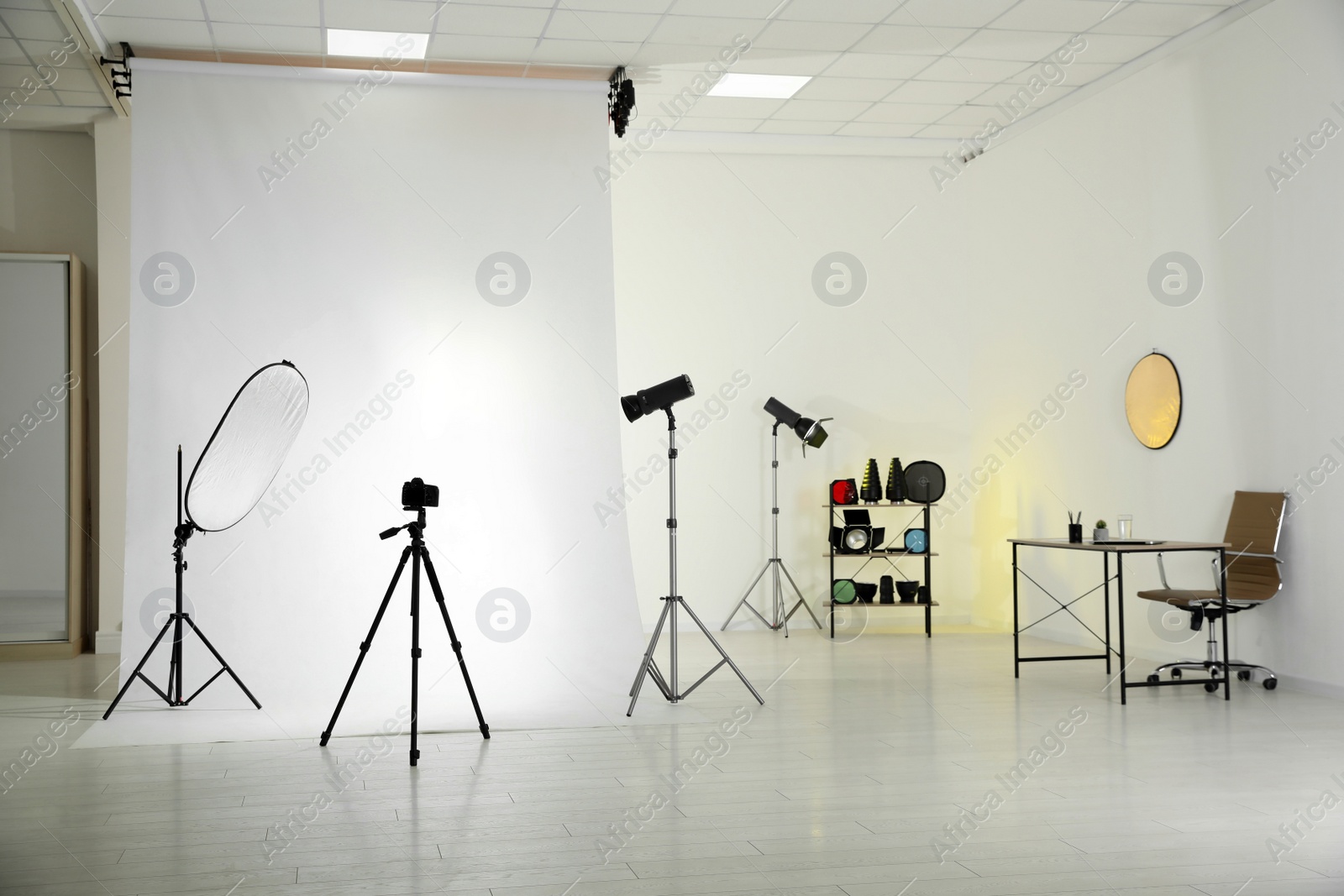 Photo of Photo studio interior with set of professional equipment and workplace