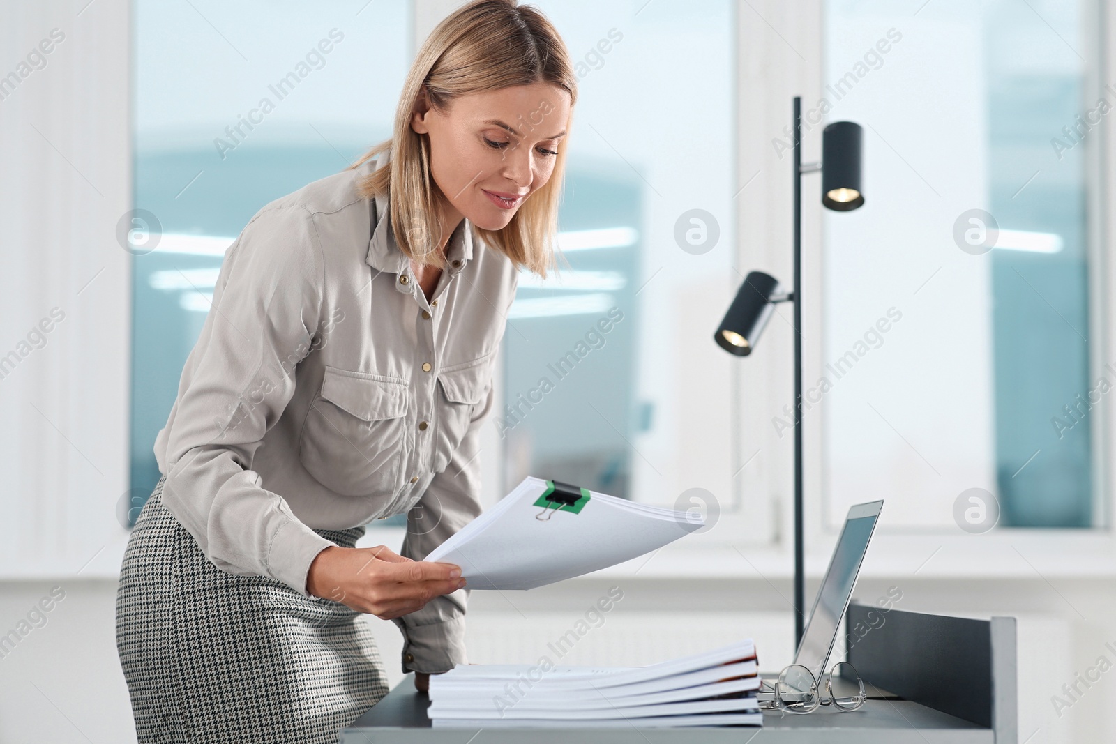 Photo of Businesswoman working with documents in modern office. Space for text